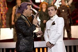 Stanley Tucci as Hunger Games host Caesar Flickerman, interviewing celebrity tribute Peeta Mellark (Josh Hutcherson)