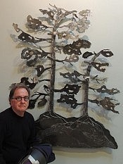 The artist poses next to one of the larger custom editions of his windswept pines (photo: David Hickey)
