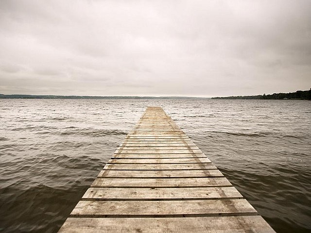 Almost sliding toward the monochromatic, the rich perspective in this photograph by Esther Vincent draws you to the contrast between the dock, waves, and sky.