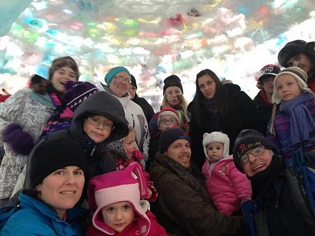 Half of the 35 people who were able to fit inside the igloo during the Apsley Winter Carnival