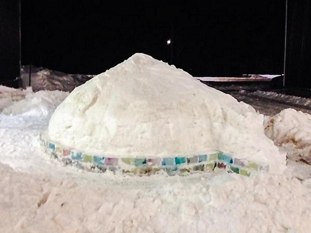 A large mound of snow is used to support the igloo while it's being built