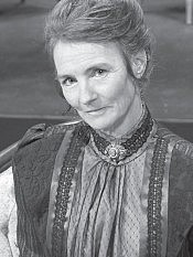 Kate Kelly as Mrs. Ravenscroft, Kate Kelly as Mrs. Ravenscroft, the widowed and flirtatious lady of the manor