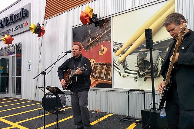 Chris Gautier and Long & McQuade CEO and President Steve  Long (who's also a musician) entertain the crowd after the ribbon-cutting ceremony