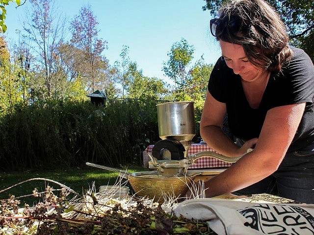 Jill Bishop, Community Food Cultivator at Nourish, demonstrates the milling of locally grown grains into homemade flour at GreenUP Ecology Park this fall