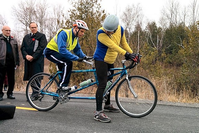 Cyclists Dave and Rick on their tandem bike, preparing to take the first official ride on the trail. Dave (left) is a blind cyclist.