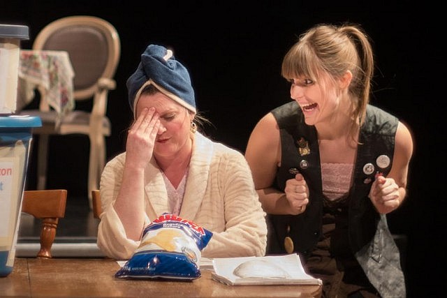 Dani Breau as Germaine, a sweepstakes winner who invites a group of women to help her paste a million stamps into booklets, with Nicole Allard as her daughter Linda (photo: Andy Carroll)